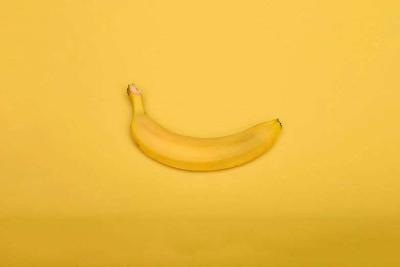 an overhead view of a banana with the edge painted yellow