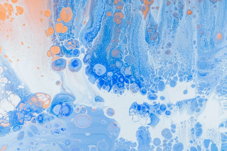 a painting with oil splatches on it that is blue and orange