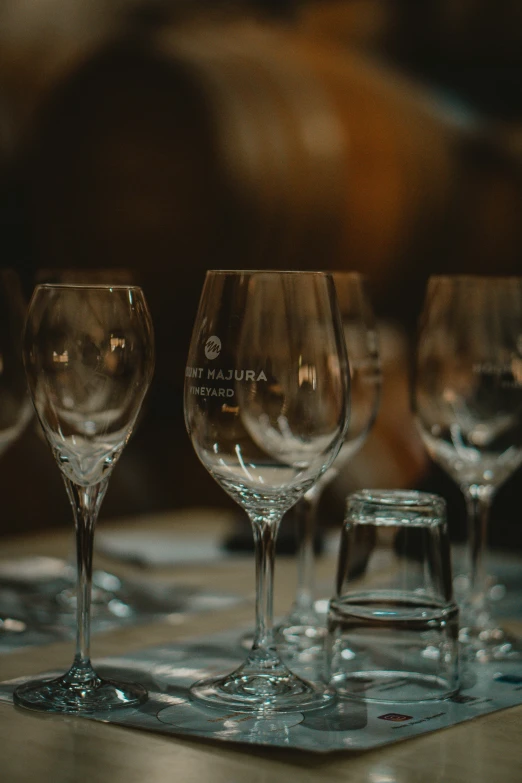 a row of wine glasses on a table in the night