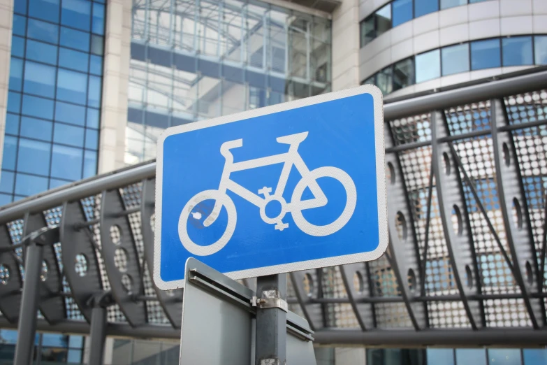 a sign warns to bicycles not to go down the road