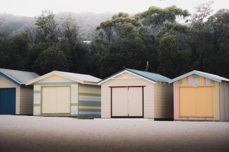 several colored sheds lined up next to each other