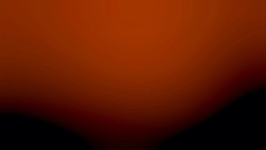 an orange and black background with some black spots