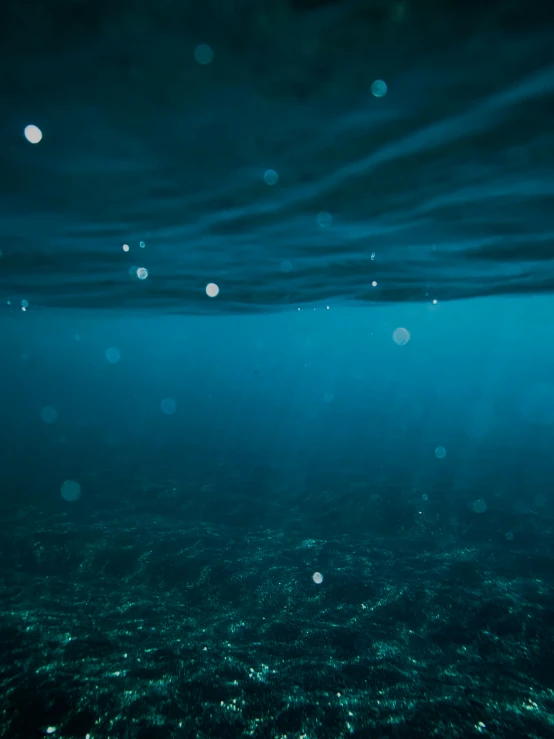 the bottom of an open water body filled with bubbles