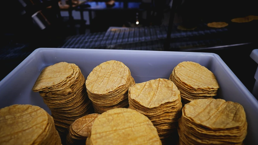 a blue box filled with cookies stacked on top of each other