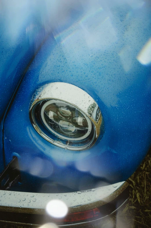 the rear view mirror of an old blue automobile