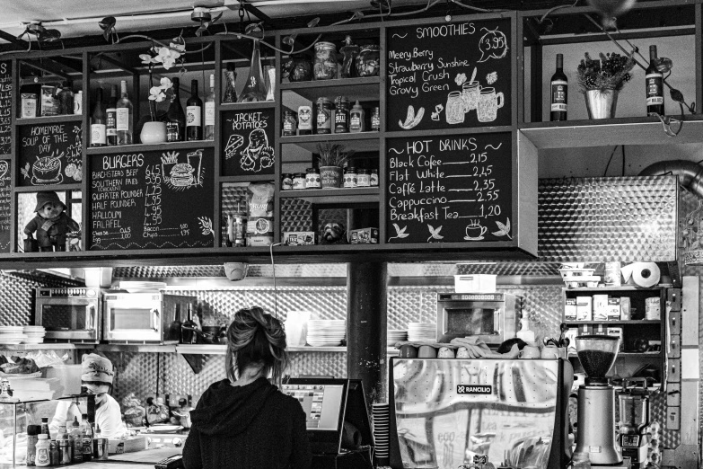 the woman is standing at the counter at the restaurant