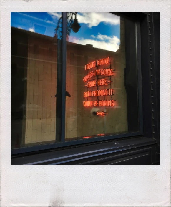 a sign in the window of a store next to the wall