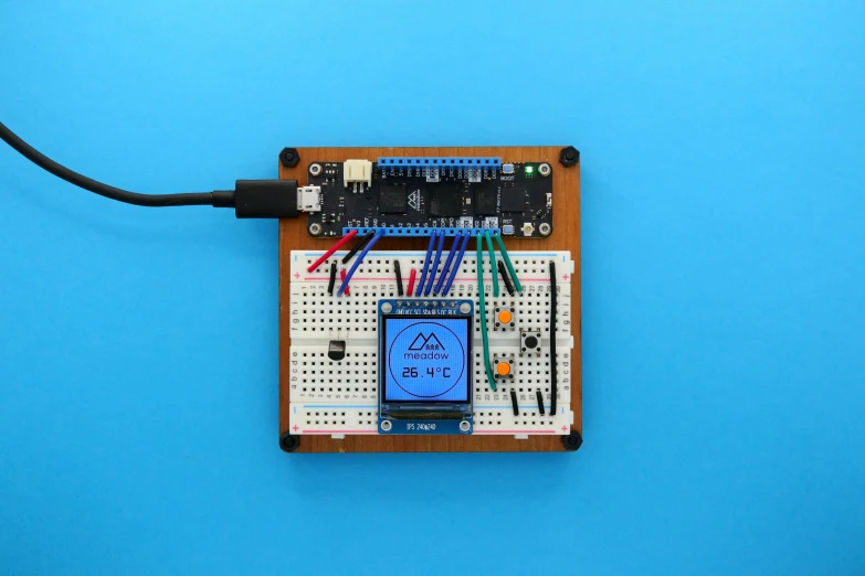 a smart phone on an electronic board with wires