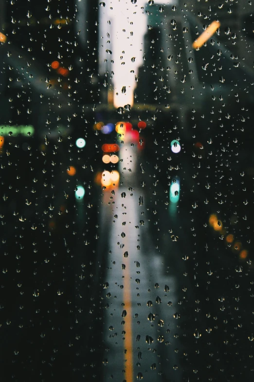 the image of rain is captured outside the window