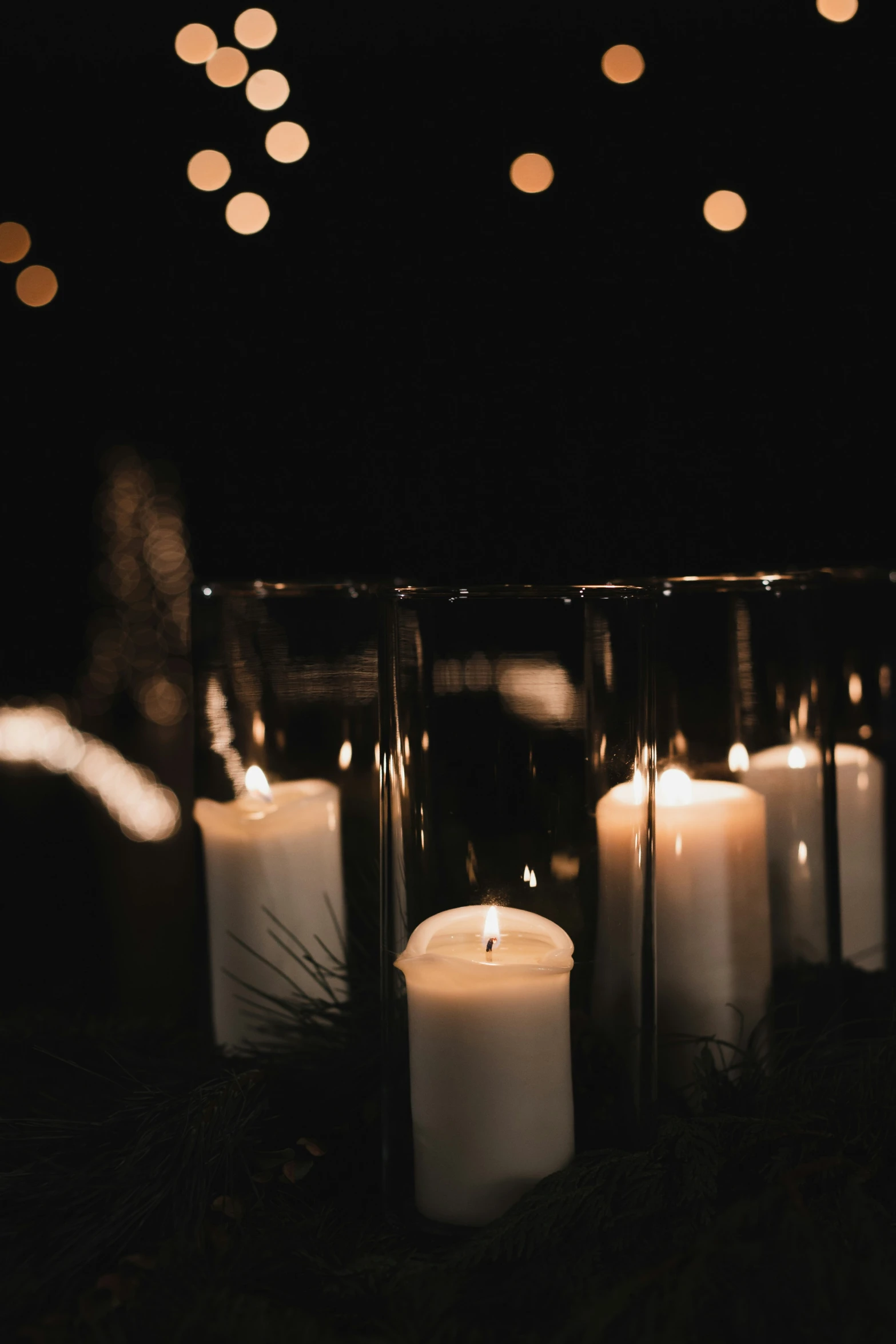 a candle that is sitting on some grass