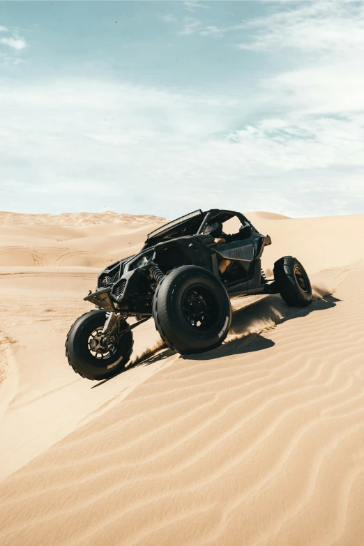 a car drives through sand dunes on a desert