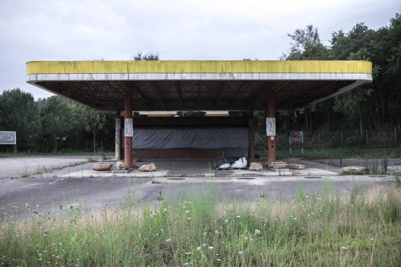 a couple of cars that are parked under a covered area