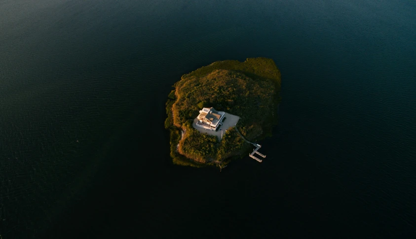 an aerial view of a house on a small island
