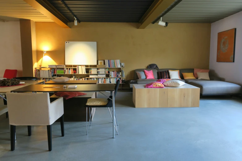 a long table with lots of books in a room