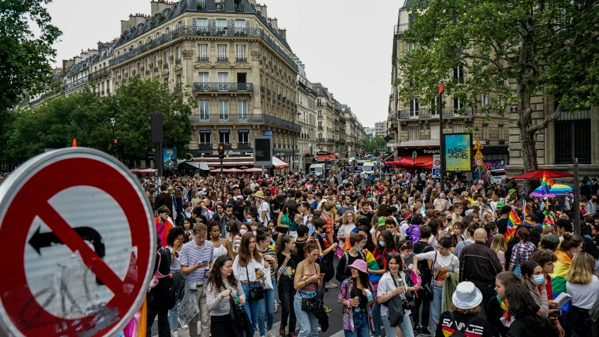 a street that has a large crowd of people walking along it