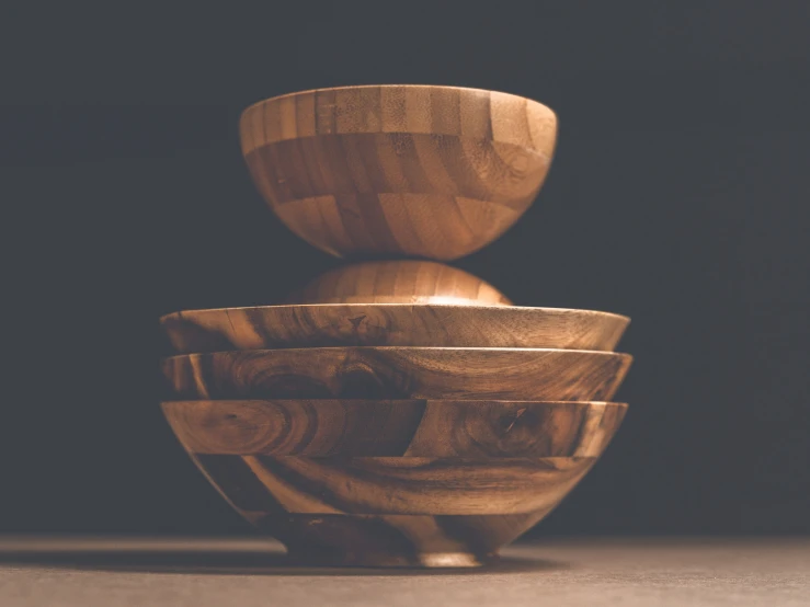 a stack of wood bowls on a table