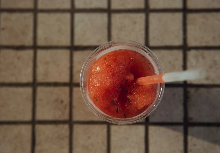 a close up of a beverage on a tiled surface