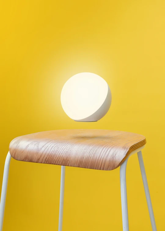 a table lamp that is on a small wooden stool