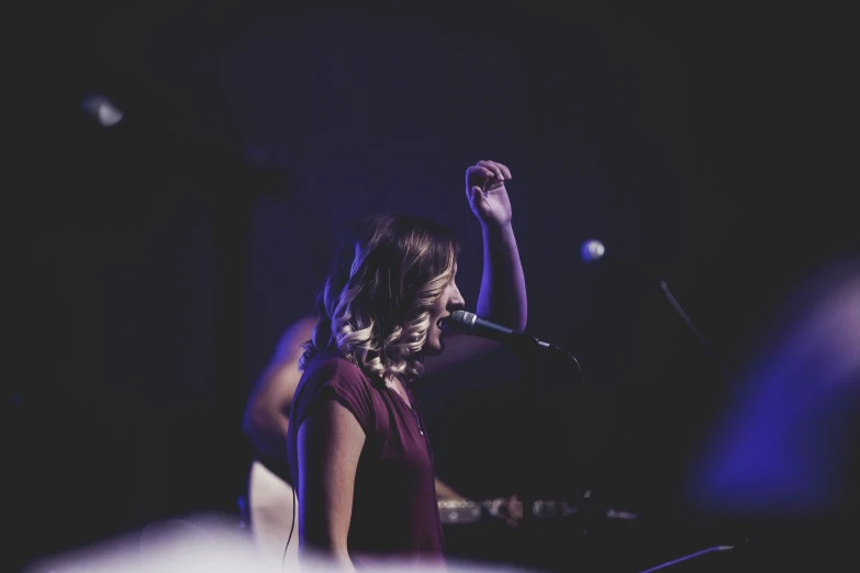 a woman with her hand raised in the air