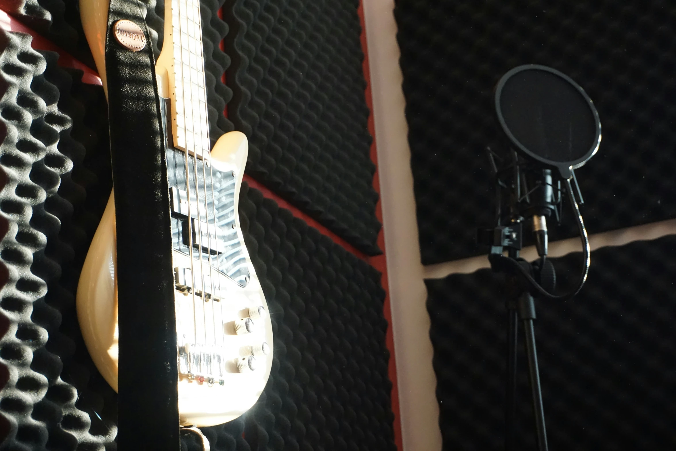 guitar next to microphone on a black and white checkered backdrop