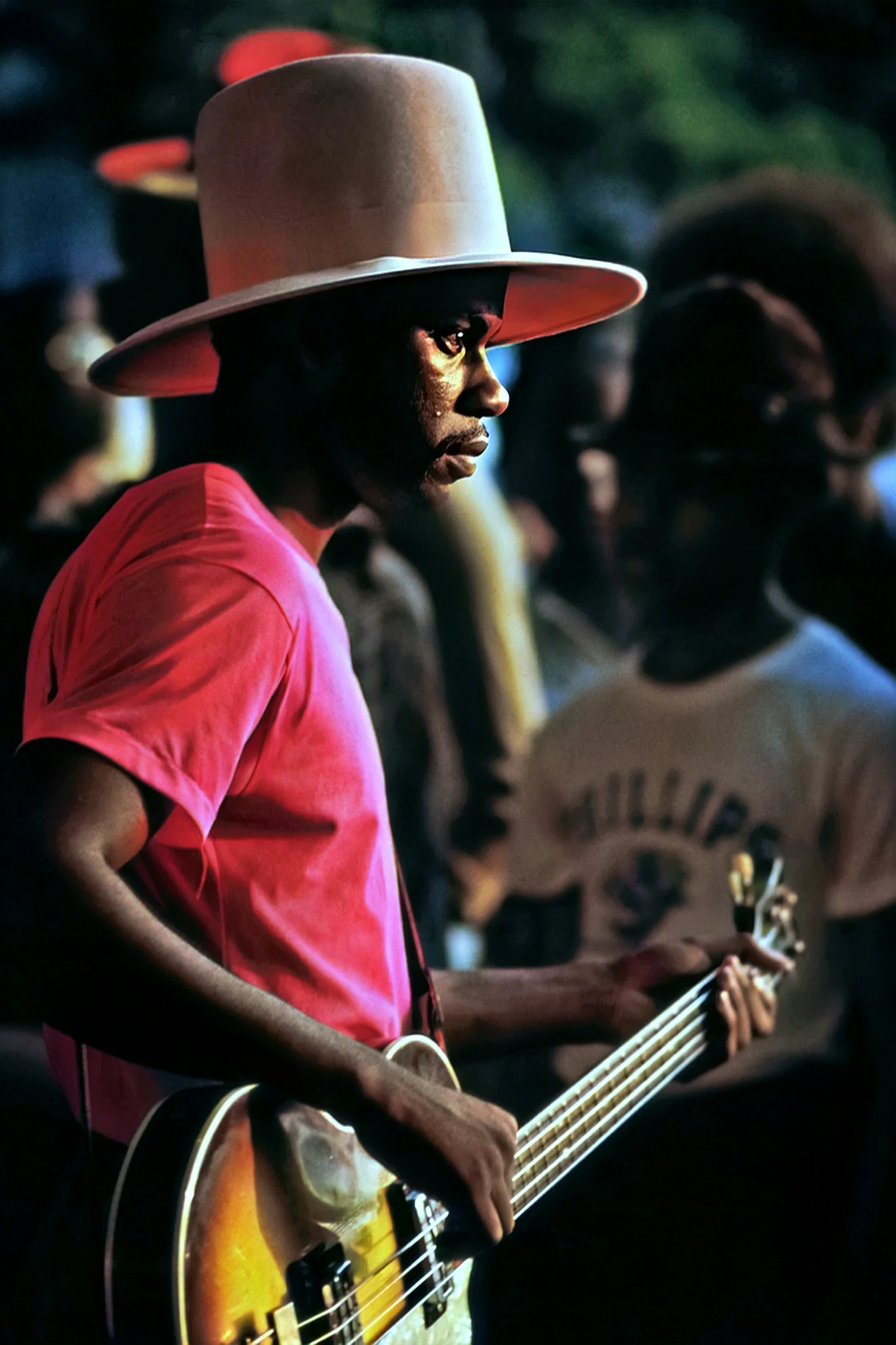 a person with a hat playing a bass