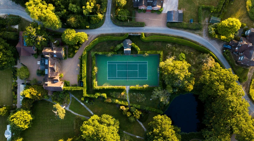 aerial view of a tennis court surrounded by houses