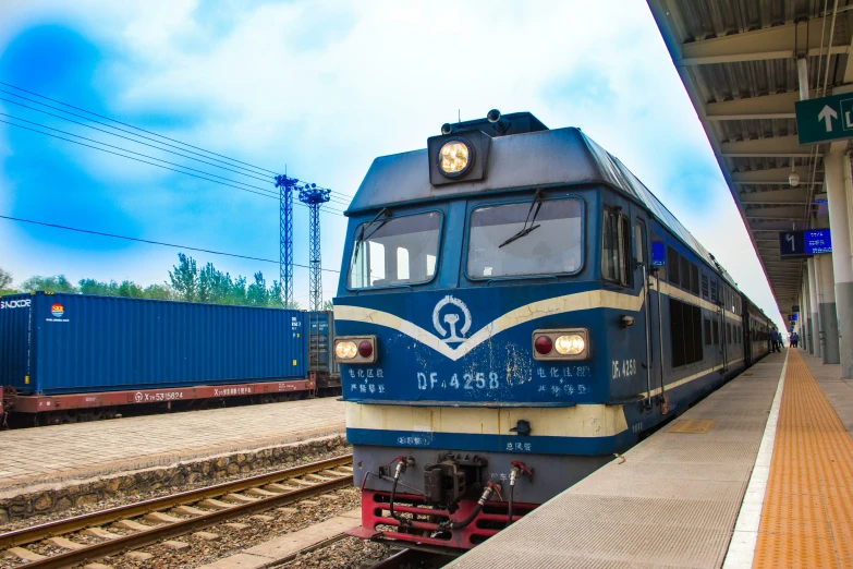 an electric passenger train waits at the platform