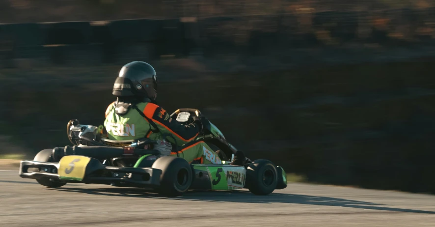 a person is riding on the go kart