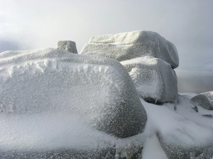 some very big rocks and snow in the sky