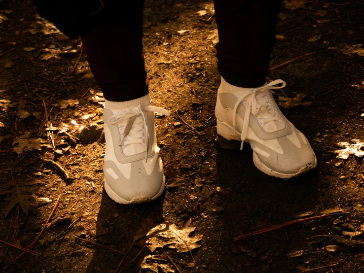 a man in white sneakers is walking down the street