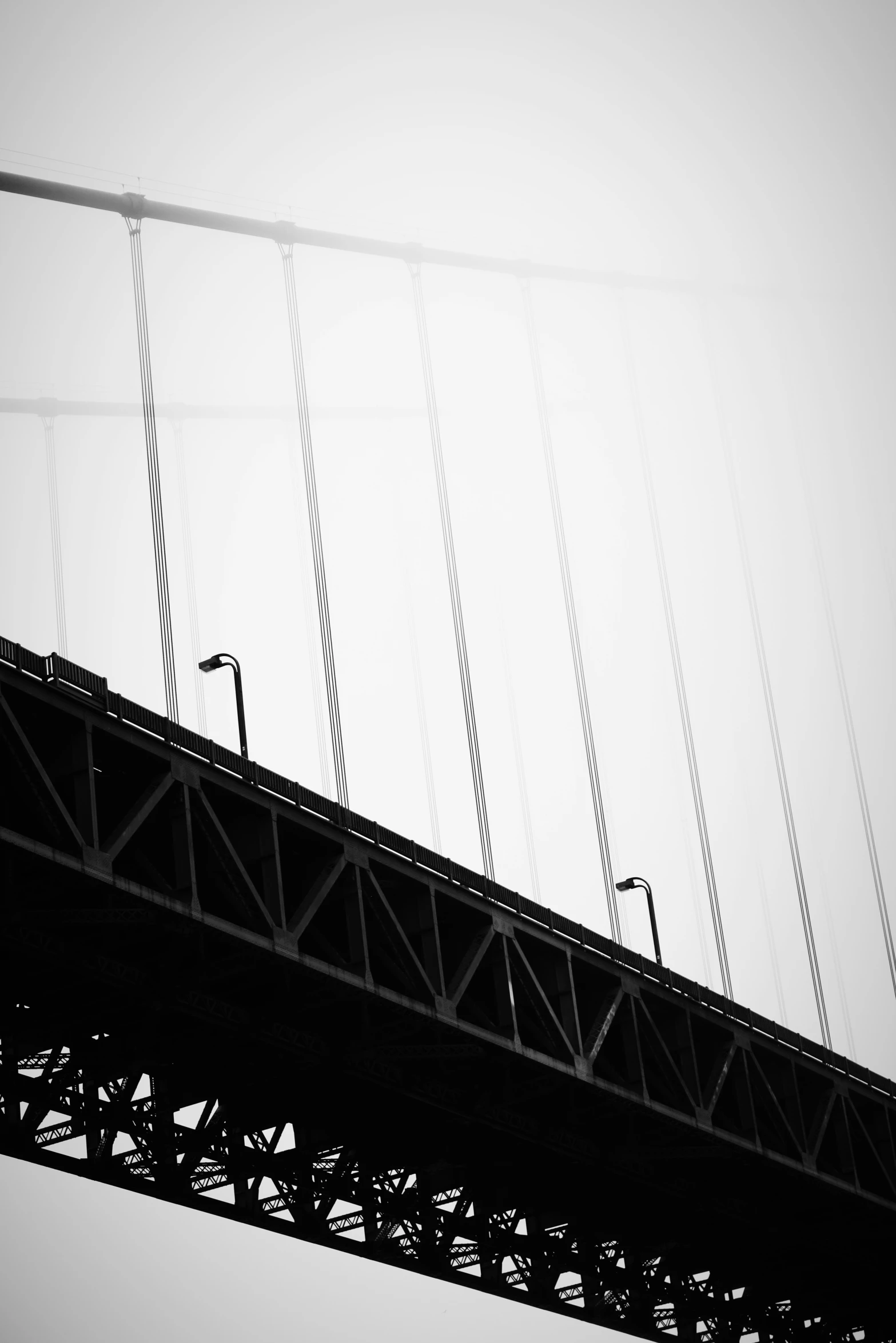 a long metal bridge is seen against the sky