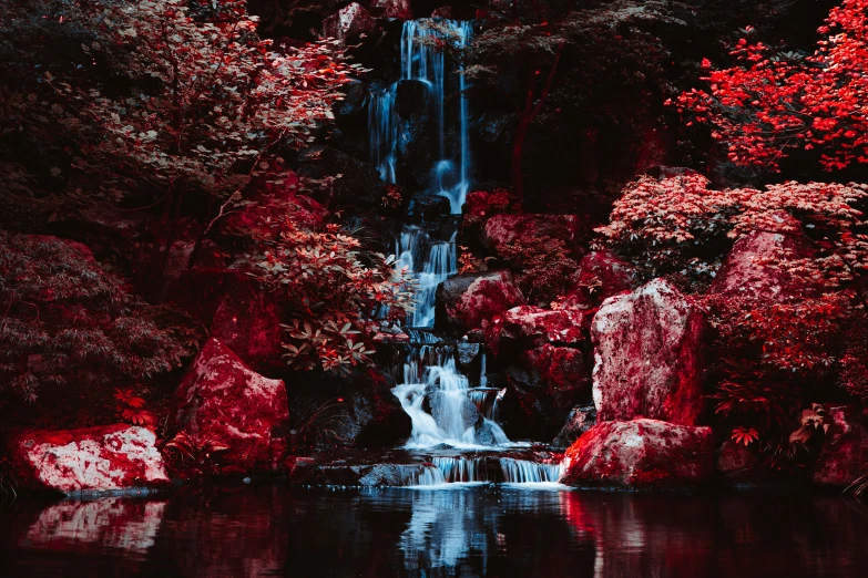 a group of large rocks next to a waterfall