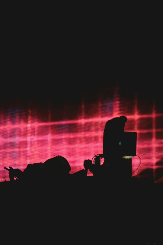 a silhouetted person on the stage during a show