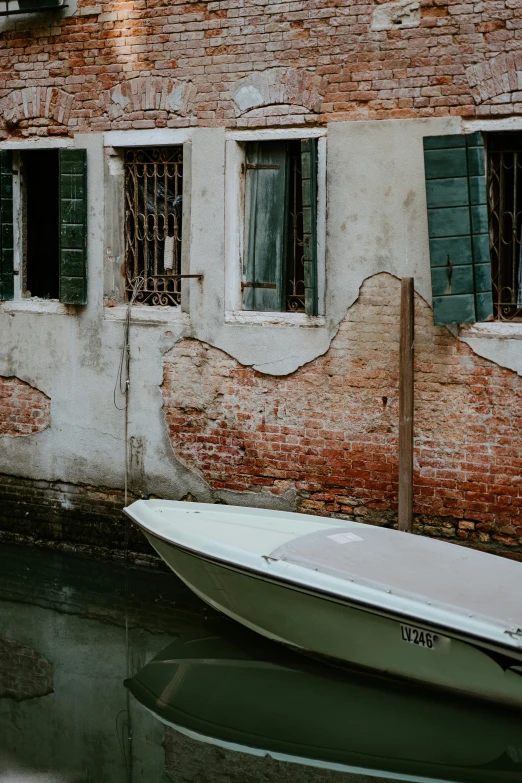 a boat parked next to a red brick building