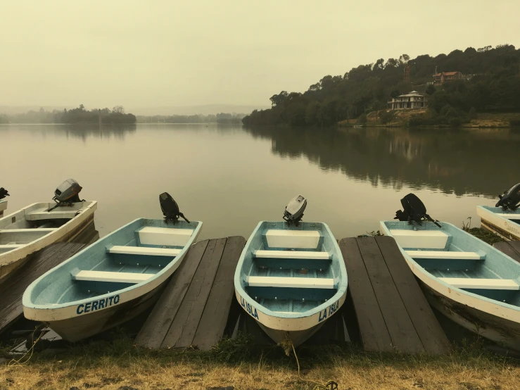 several boats sitting at the end of a pier