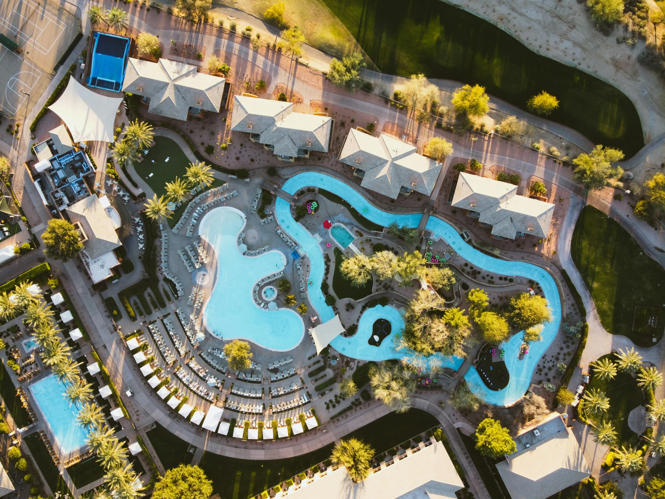 an aerial view of a swimming pool with other pools