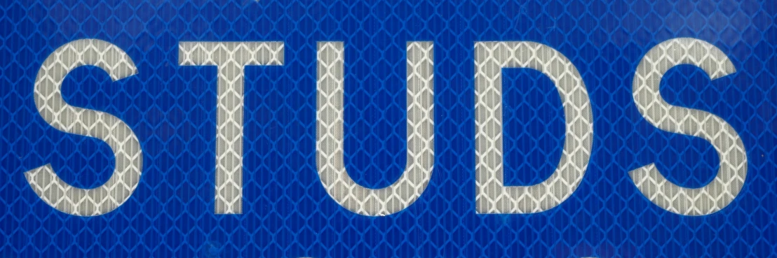 the word studs on a bright blue sign