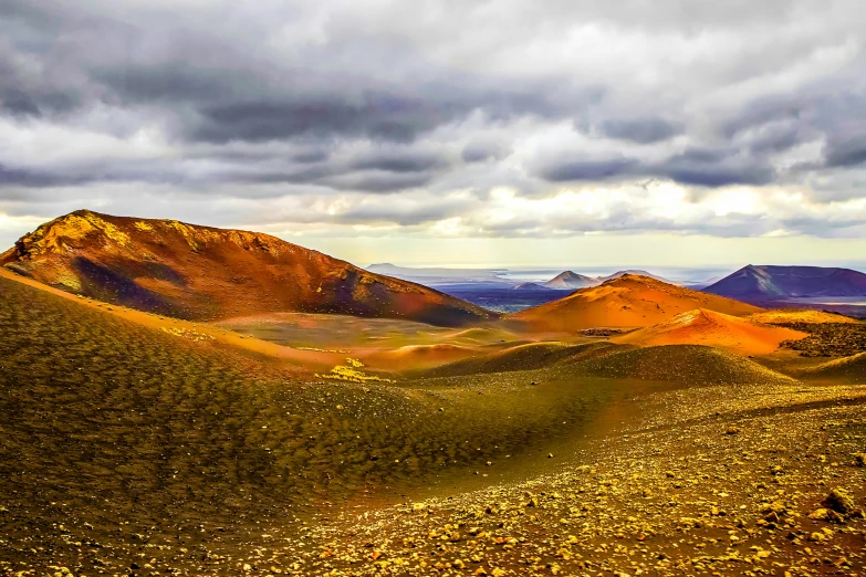 a landscape of desert land and mountains with very few cloud formations