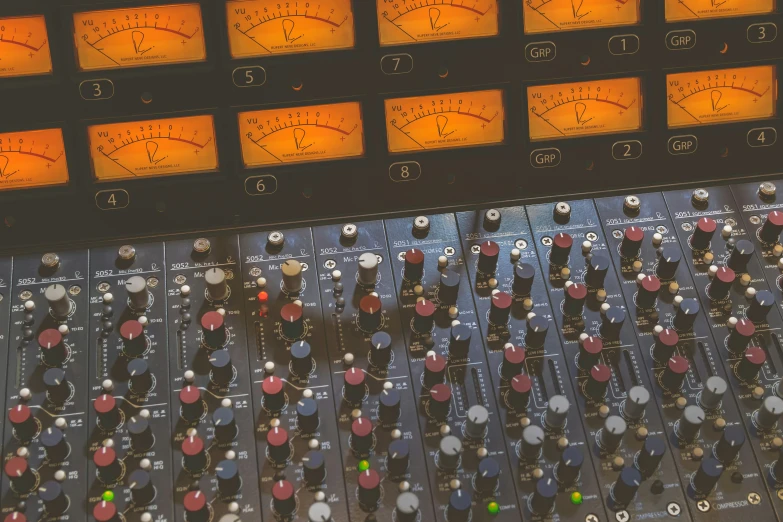 a close up of an electronic sound mixing console