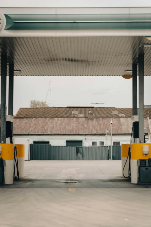 a gas station is shown with yellow barriers