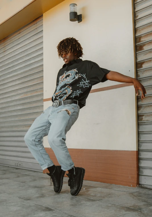 a man on his skateboard is leaning against a wall