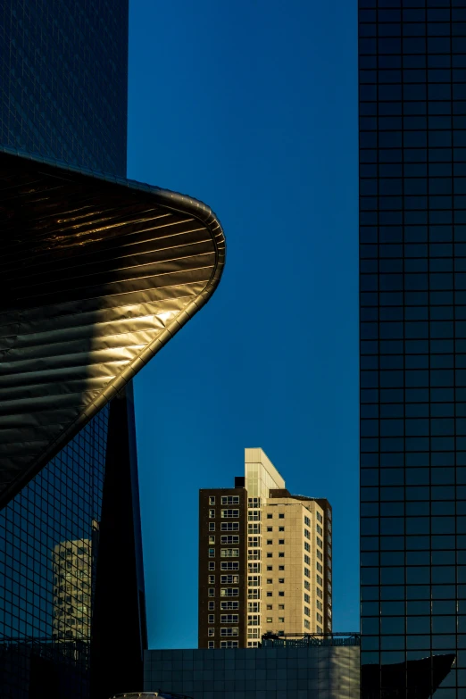 a city skyline with tall buildings and a curved roof