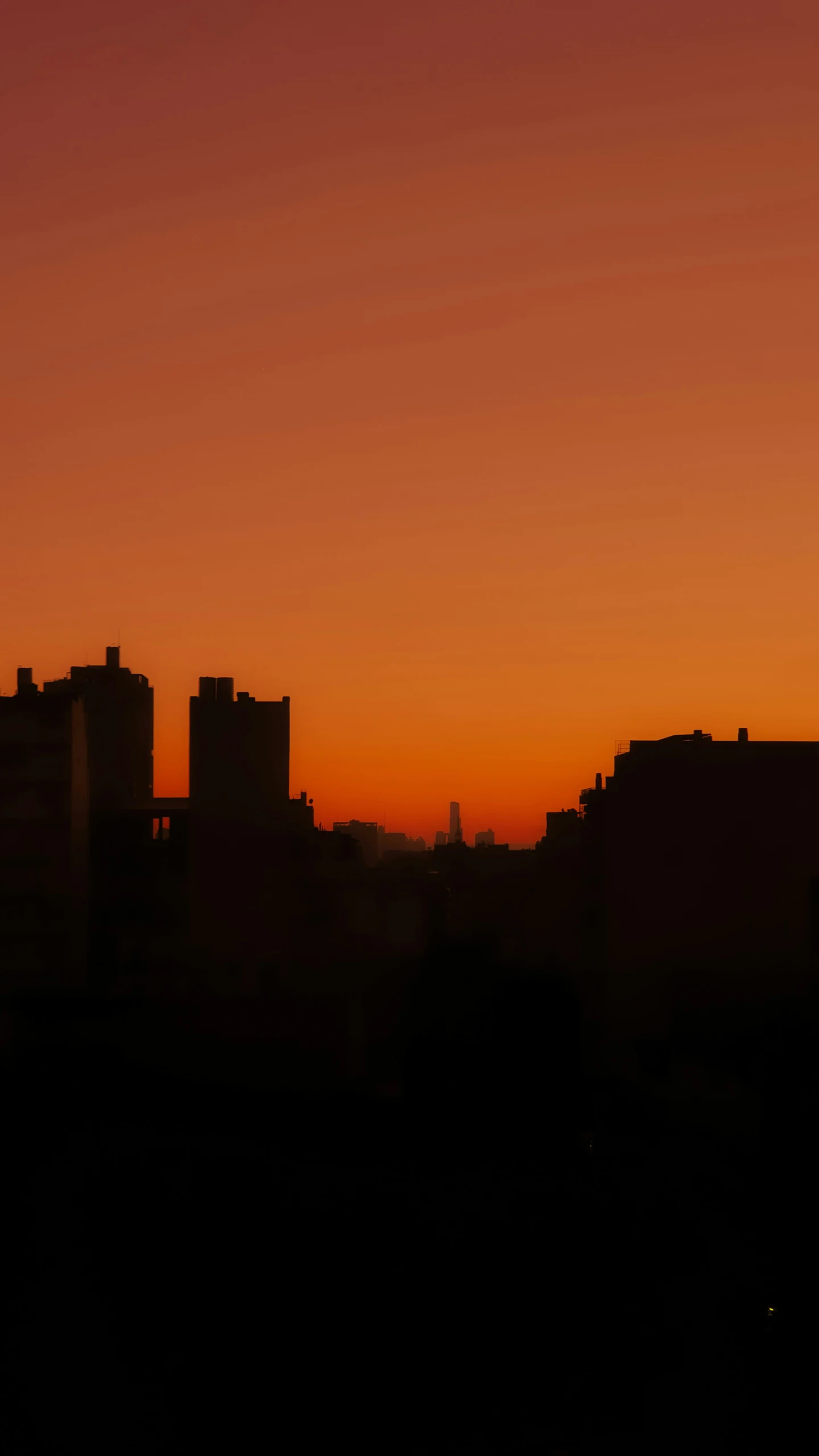 city skyline at sunrise with red sky in background