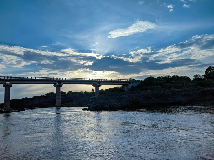 a bridge across the river and a boat in the water