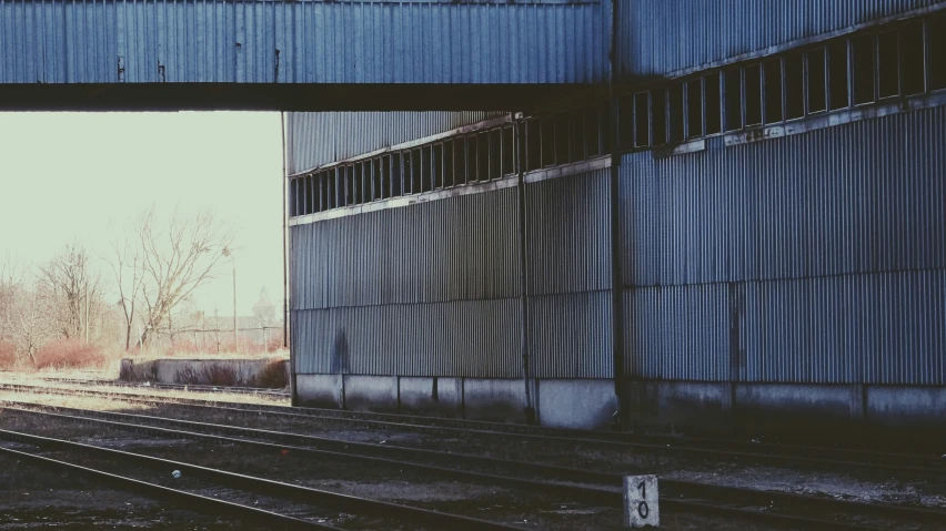 a set of train tracks near an overpass