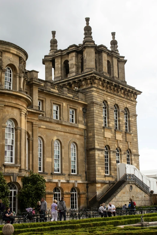 several people are outside a large building