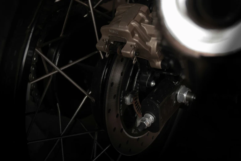 a close up view of a disc and a spoke on a motorcycle