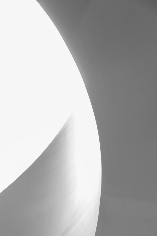 a close up of a white circle on grey wall