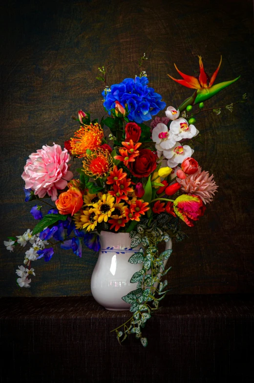 a vase full of bright colored flowers sitting on top of a table