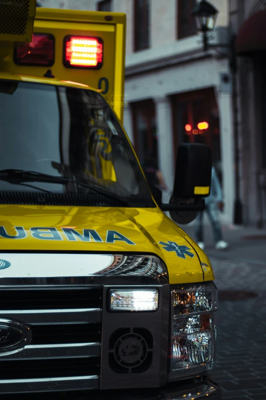 an ambulance parked on a sidewalk near a building